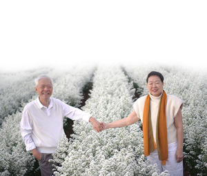 Full length of a smiling young man standing outdoors