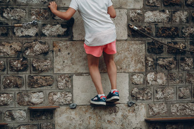 Low section of woman standing on staircase