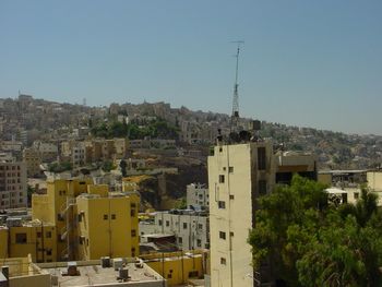 View of buildings in city against clear sky