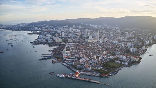 High angle view of buildings by sea against sky