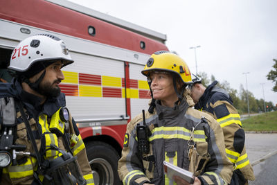 Firefighters in front of fire engine