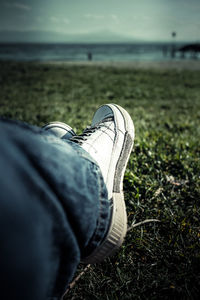 Low section of man wearing shoes