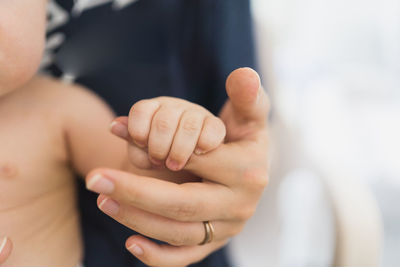 Cropped image of couple holding hands in a summer day at home