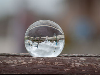 Close-up of crystal ball on wooden table