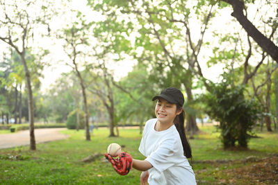 Side view of young woman holding umbrella