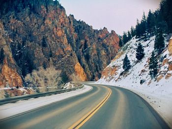 Road by mountain during winter