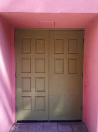 Closed door of pink building