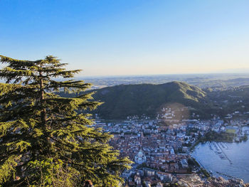 High angle view of tree by city and mountain against sky