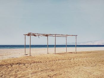 Lifeguard hut on beach against sky