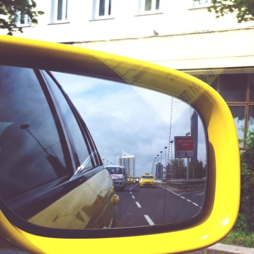 yellow, transportation, architecture, built structure, mode of transport, land vehicle, building exterior, sky, car, city, street, glass - material, day, window, road, tree, outdoors, close-up, protection, no people