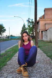 Portrait of beautiful young woman sitting outdoors