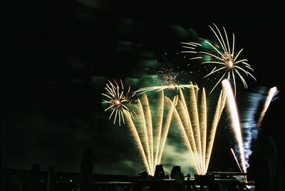 Low angle view of firework display at night