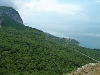 Scenic view of sea and mountains against sky