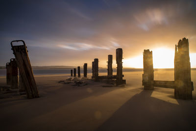 Scenic view of beach against sky during sunset