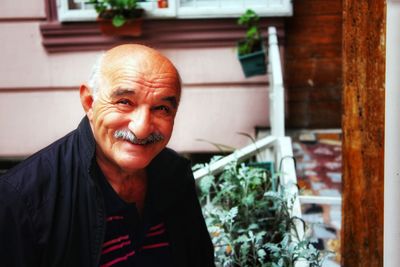 Portrait of smiling mature man at backyard