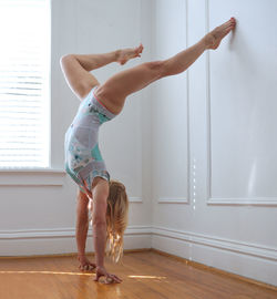 Side view of woman exercising at home