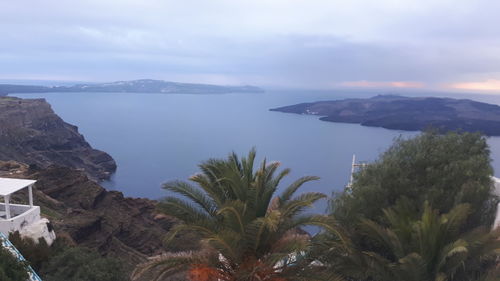 Scenic view of sea and mountains against sky