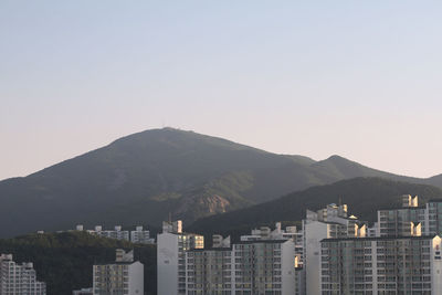 Cityscape with mountain range in background