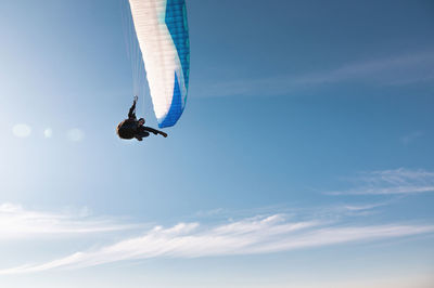 Athlete flies on a paraglider. beautiful paraglider in flight on a blue sky with white clouds on a