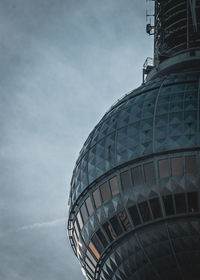 Low angle view of building against cloudy sky