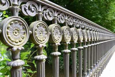 Close-up of metal gate against plants