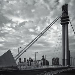 View of suspension bridge against cloudy sky