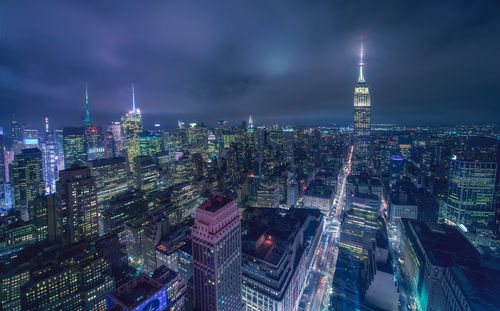 Aerial view of city lit up at night