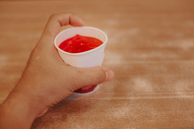 Close-up of hand holding bowl