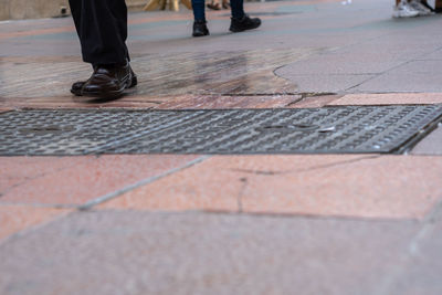 Low section of people walking on footpath