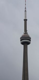 Low angle view of communications tower against sky