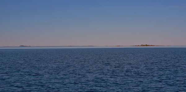 Scenic view of sea against clear sky during sunset