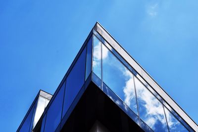 Low angle view of modern building against blue sky