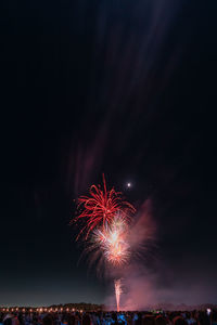 Low angle view of firework display at night