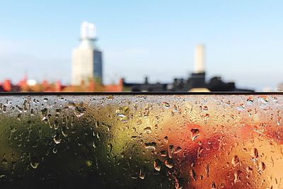 Close-up of wet city against sky