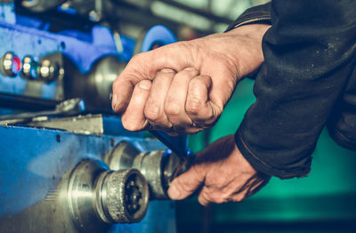 Midsection of man repairing car