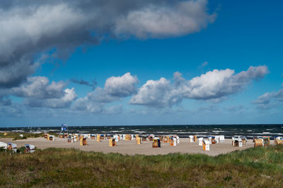 Group of people on beach against sky