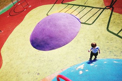 High angle view of girl standing by railing