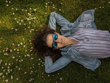 High angle portrait of woman relaxing on field