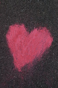 Close-up of red heart shape on road