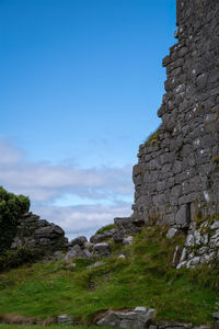 Low angle view of rock formation against sky