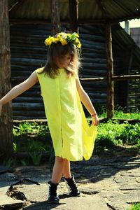 Full length of woman with yellow umbrella