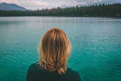 Rear view of woman against lake