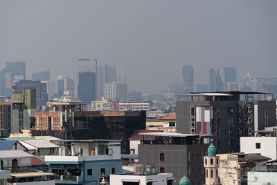 High angle view of buildings in city against sky