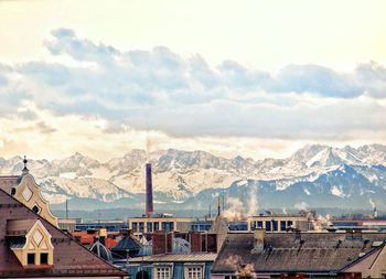 Houses in town against sky during winter
