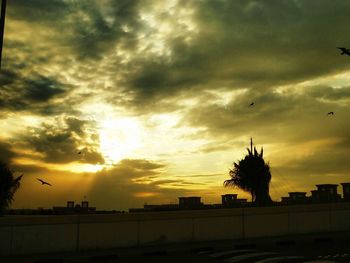 Silhouette of landscape against dramatic sky