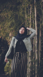 Young woman looking at camera in forest