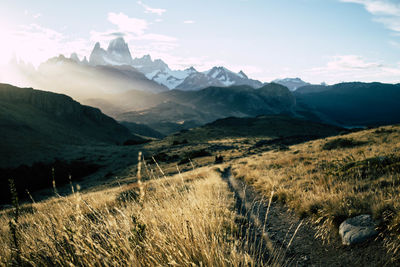 Scenic view of snowcapped mountain peak against sunset sky