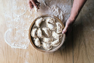 Midsection of person preparing food in bowl