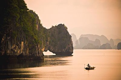 Boat in sea at sunset