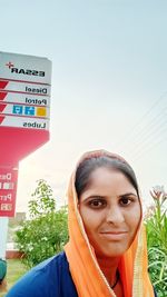 Portrait of woman standing against sky